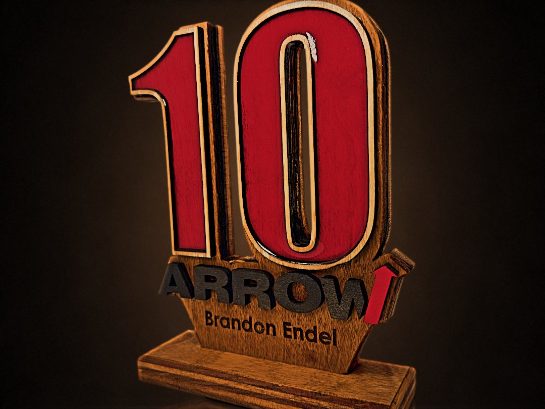 Layered 10-year anniversary award with red epoxy numbers and the Arrow logo, engraved for Brandon Endel