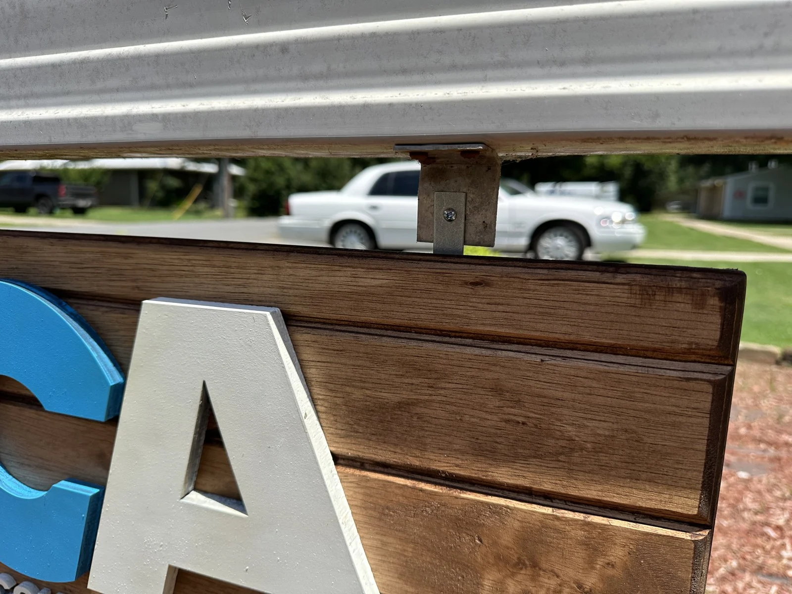 Dimensional white letter and stained wood boards on a business sign
