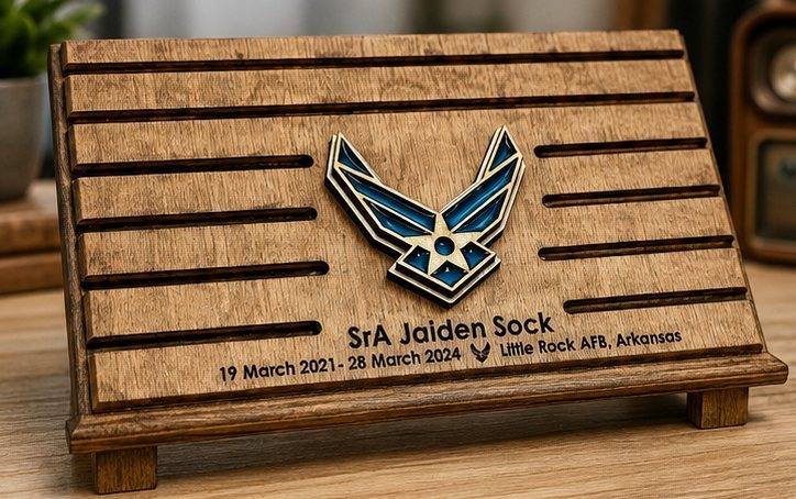 Stained wood USAF challenge coin holder with a layered Air Force emblem and an engraved name, dates and Little Rock AFB duty station