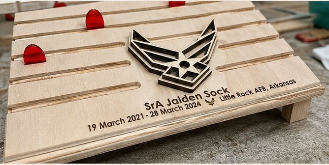 Natural-wood coin holder with challenge coins displayed in the rows