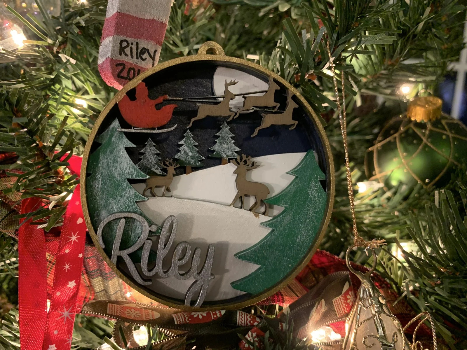 Personalized Riley ornament with a layered winter scene