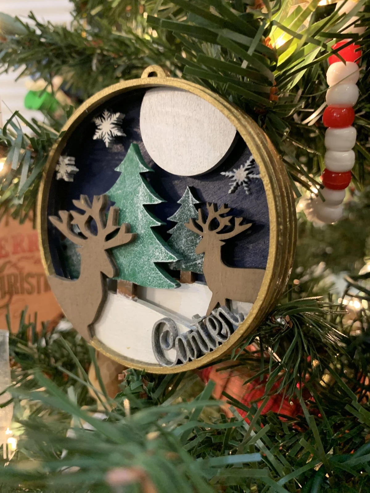 Personalized layered Carter ornament hanging on a Christmas tree