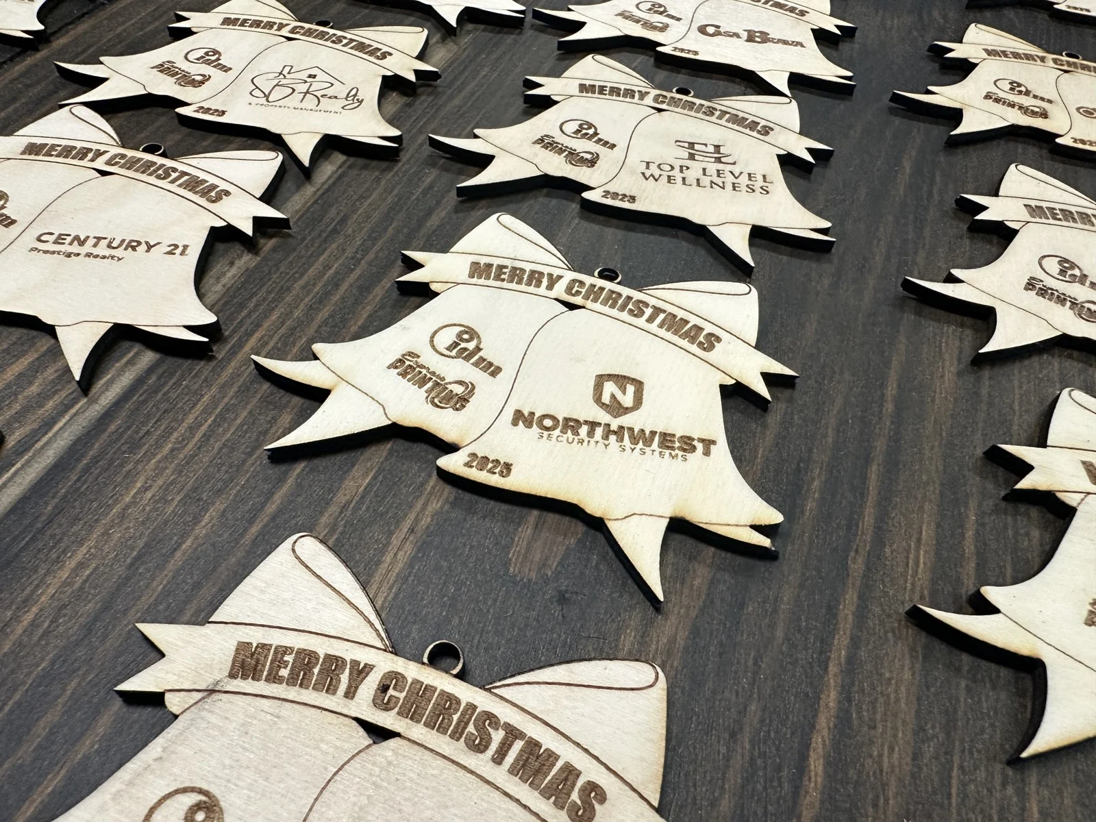 Close-up of engraved holiday ornaments with business logos