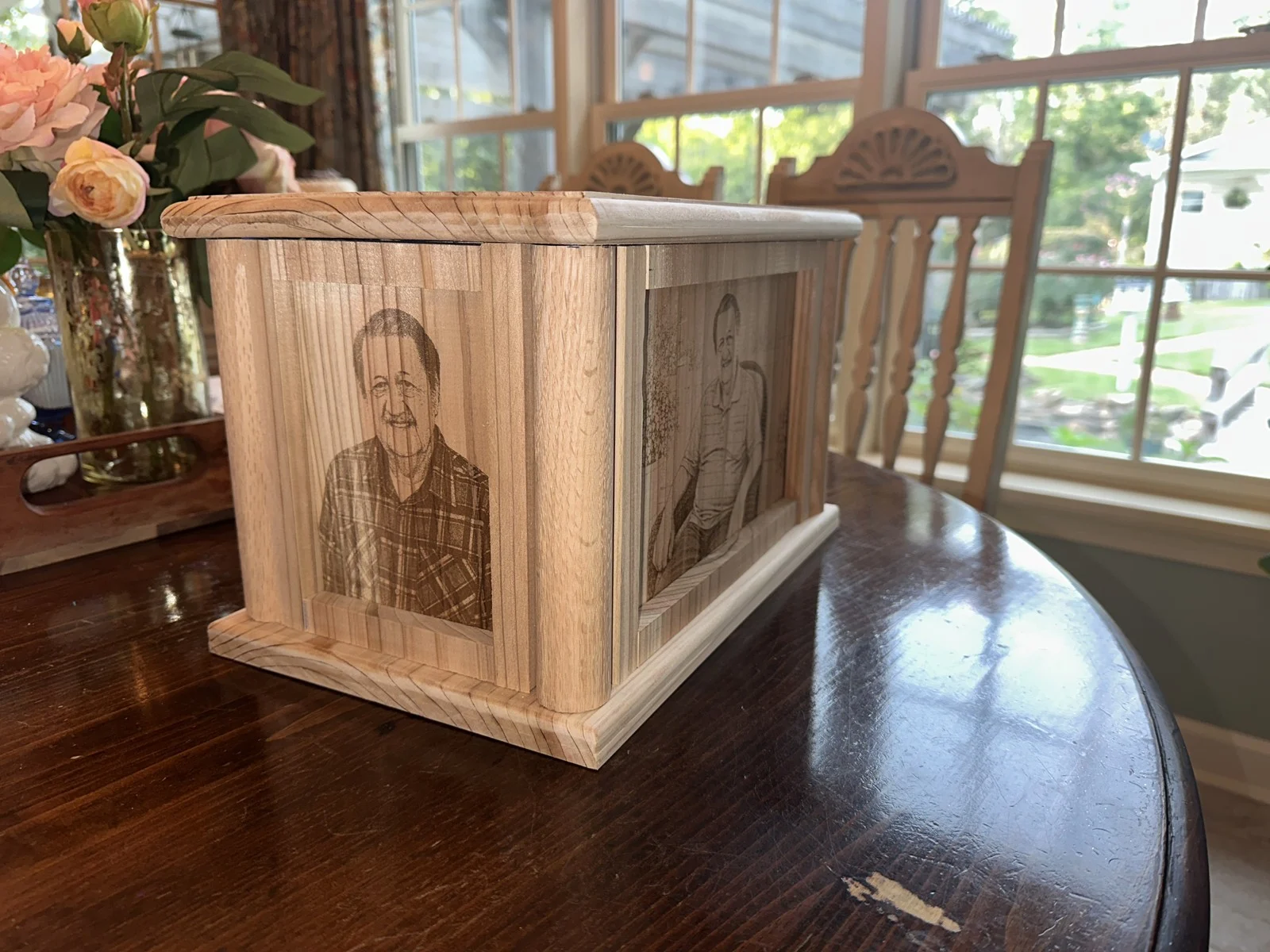 Cedar urn with engraved portraits on two framed sides