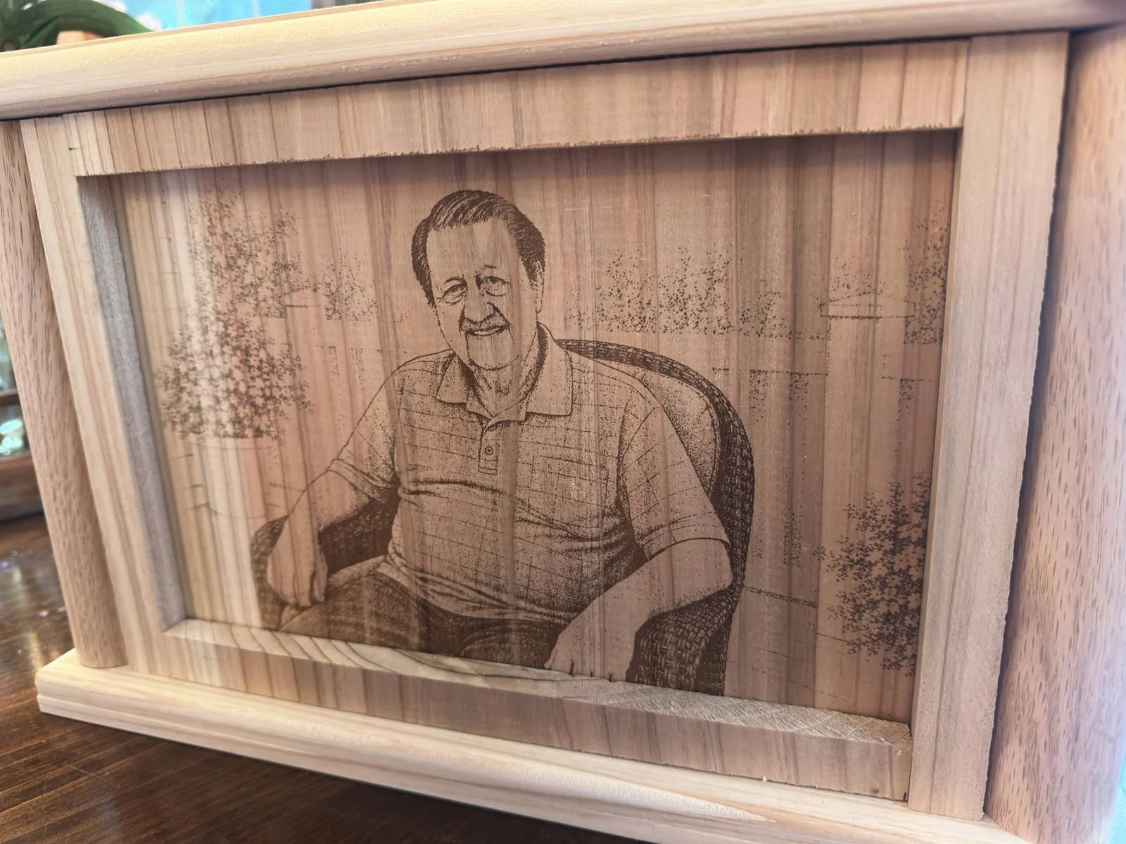 Close view of an engraved portrait within a wood frame