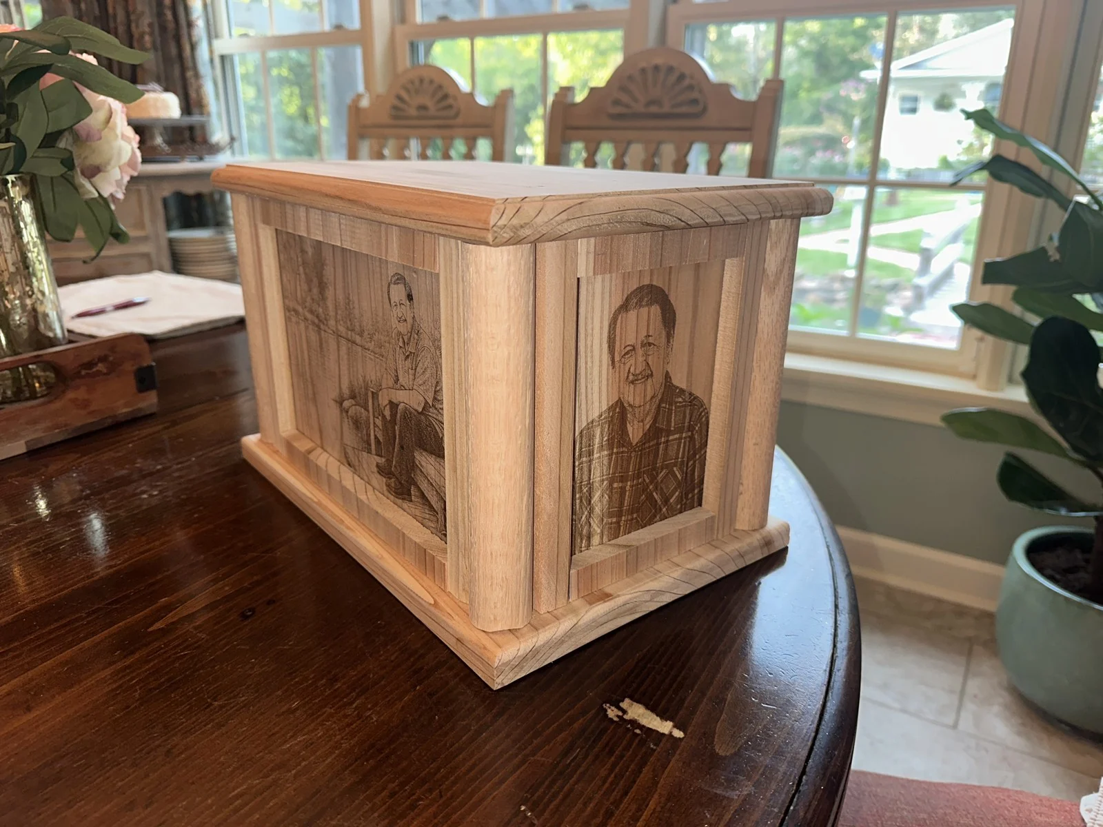 Portrait engraving and side panels on a handcrafted urn