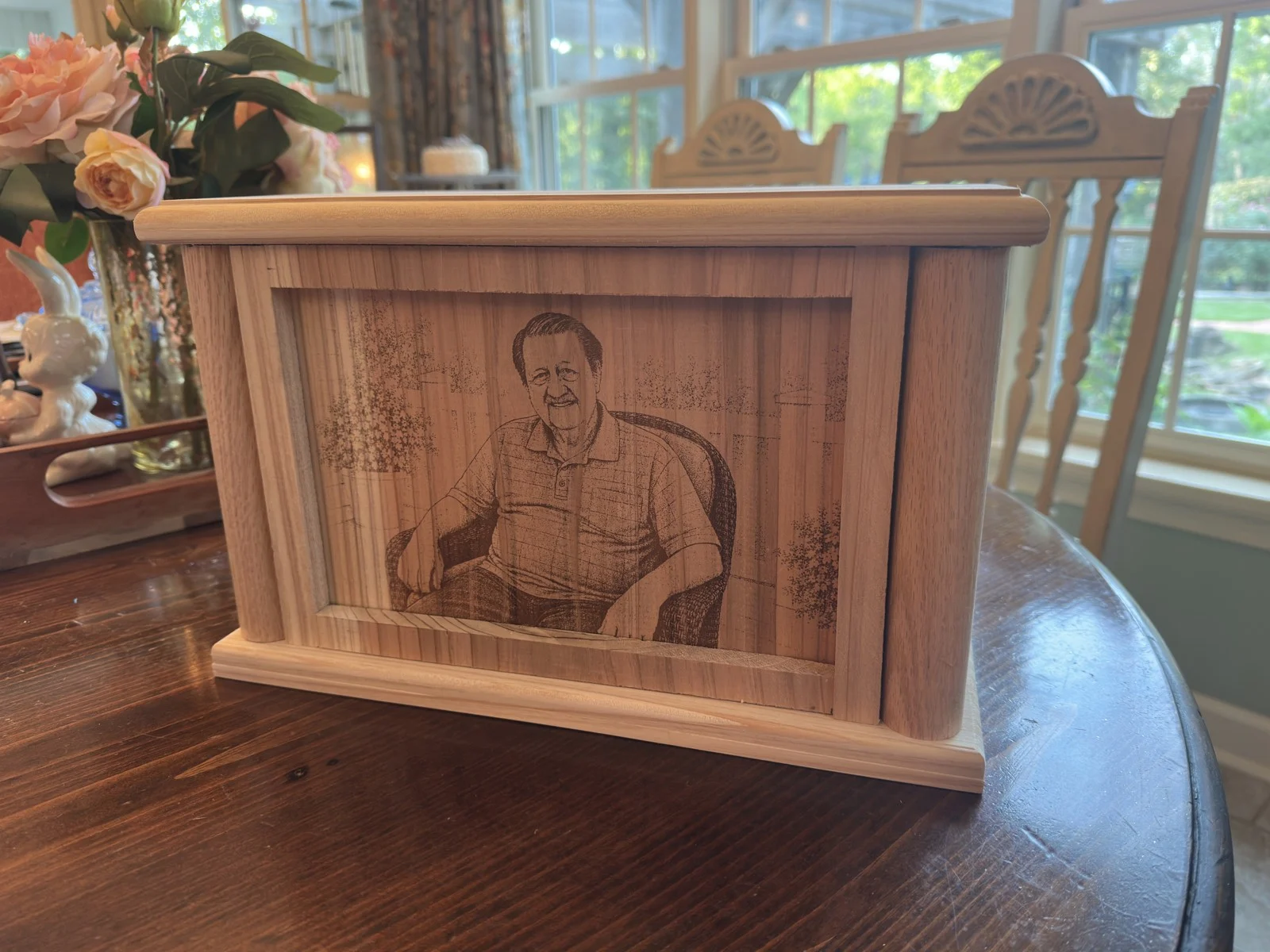 Front view of the framed engraving on a cedar urn