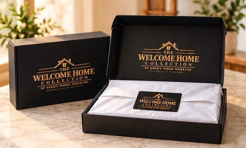 Open black Welcome Home Collection gift box with tissue paper and a branded card, ready to give