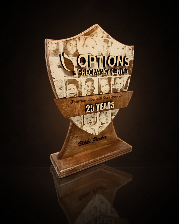 Shield award with an engraved photo collage celebrating 25 years